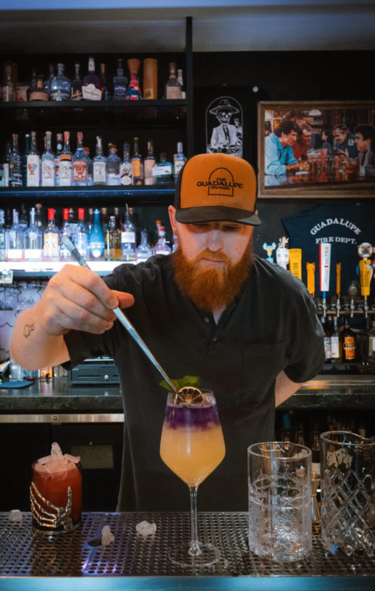 Michael Schreier building a cocktail behind the bar at The Guadalupe on Main in Mesa, Arizona